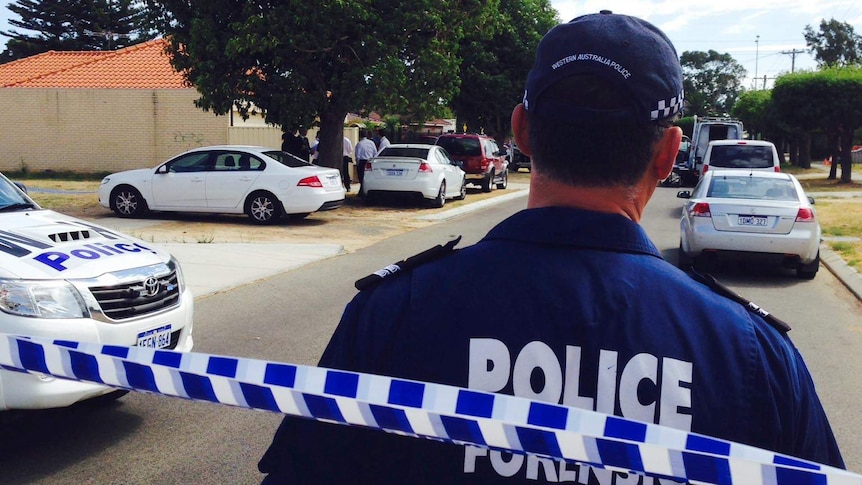 A police officer stands in front of police tape in Midland