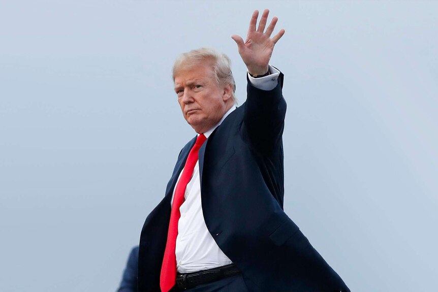 Donald Trump waves at the camera