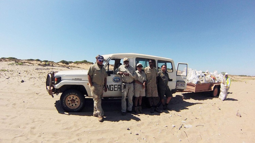 Mapoon land and sea rangers on beach at far northern tip of Qld Cape York.