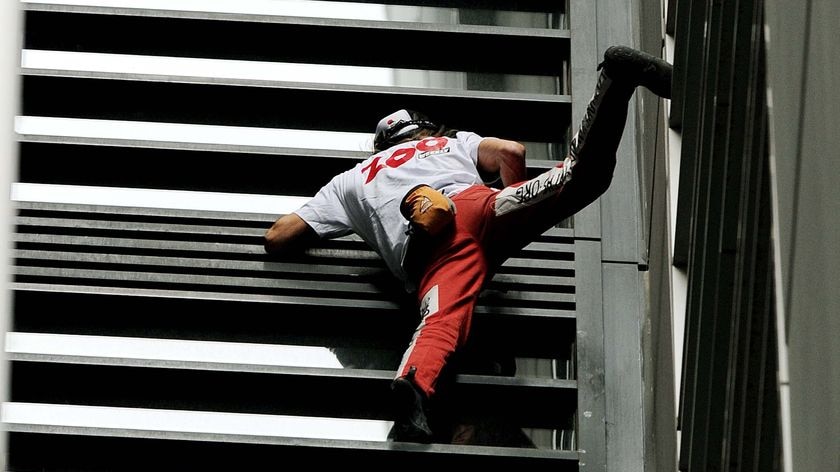 High drama: Frenchman Alain Robert, known as Spiderman, climbs the150-metre tall Lumiere apartment building in Sydney.