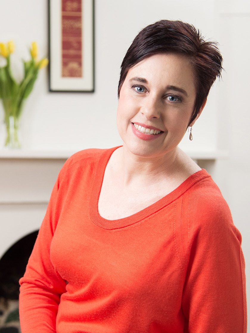 A woman with short hair and a red top