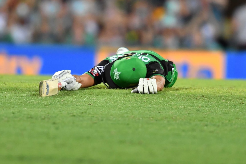 Marcus Stoinis lies on the ground after being run out for the Stars against the Heat in their BBL match at the Gabba.