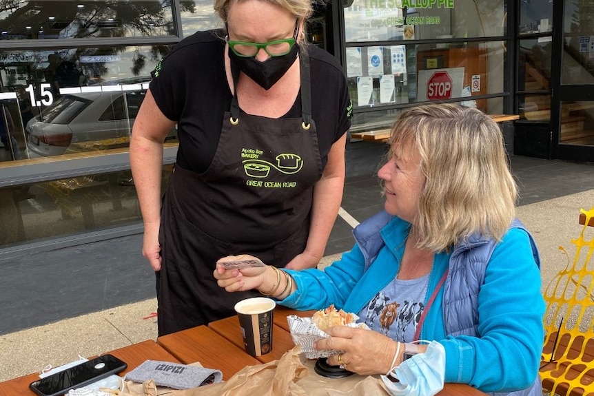 Bakery owner serving a customer