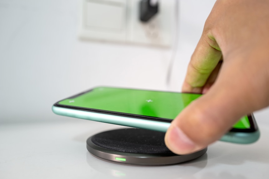 A phone being charged with a wireless charging device