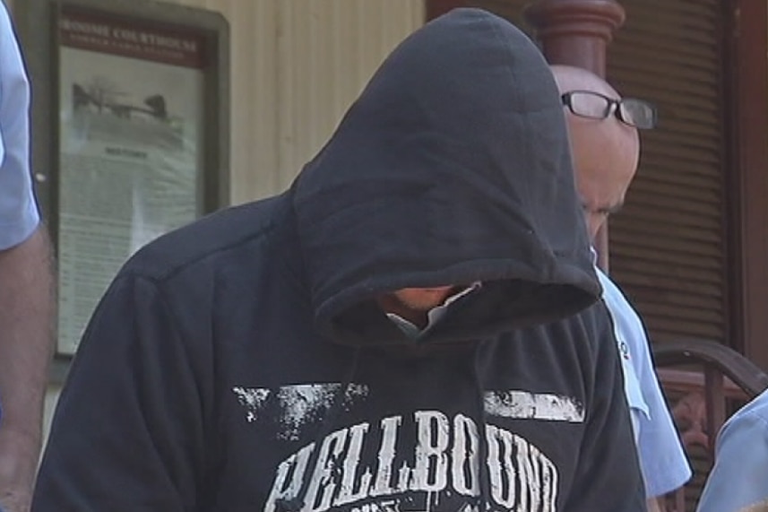 Sammy Jonathon Hietanen hides his face under a hoodie jumper as he leaves the Supreme Court in Broome surrounded by police.