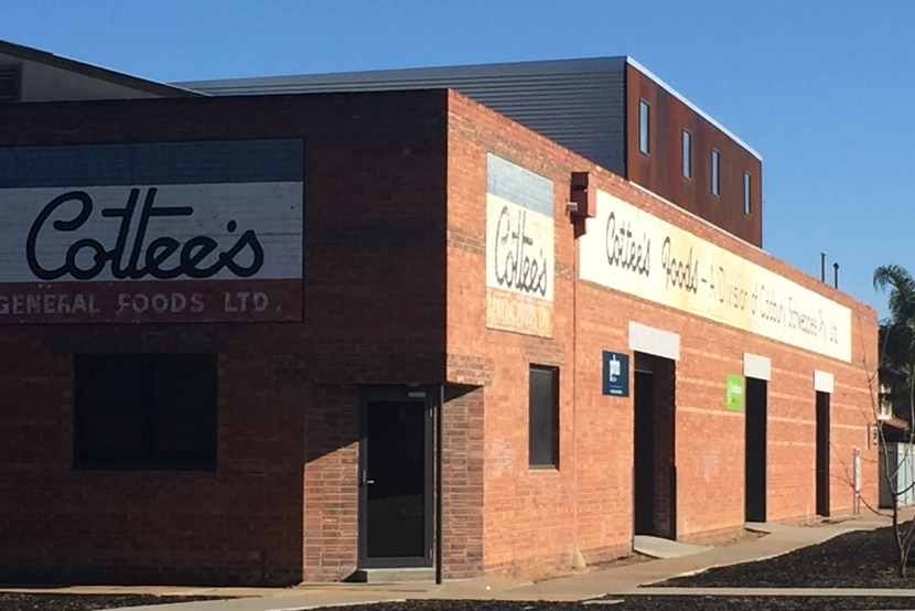 Historic red-brick in Mildura displaying old Cottees signs.