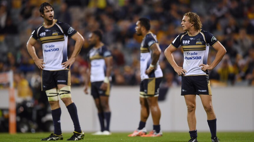 Brumbies' Joe Powell (R) reacts during the Super Rugby match against the Highlanders in Canberra.