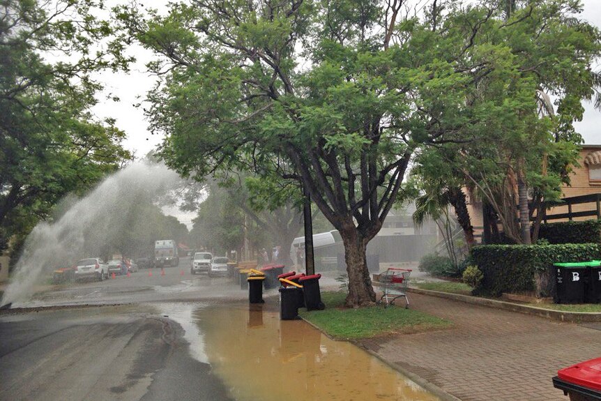 Water sprays higher and starts to shower houses in the street
