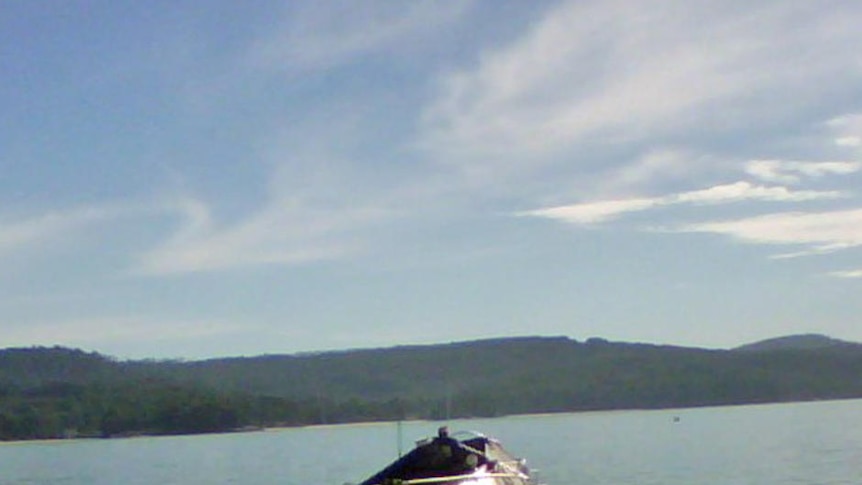 A fishing boat is towed into Adventure Bay Bruny Island after capsizing.