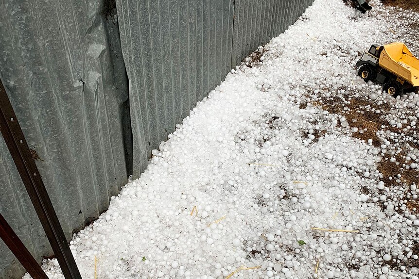 Hail on the ground against a fence during storm at Mt Tyson, west of Toowoomba.