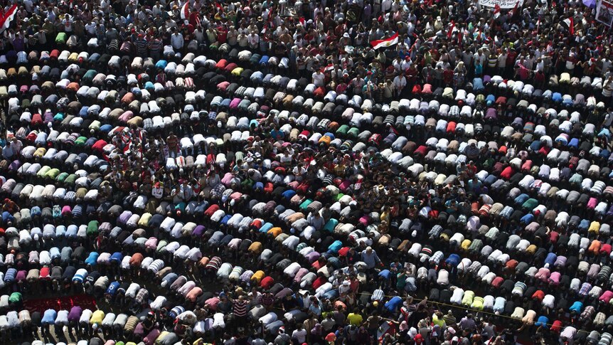 Opponents of Egyptian president Mohamed Morsi pray during a protest