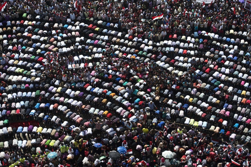 Opponents of Egyptian president Mohamed Morsi pray during a protest