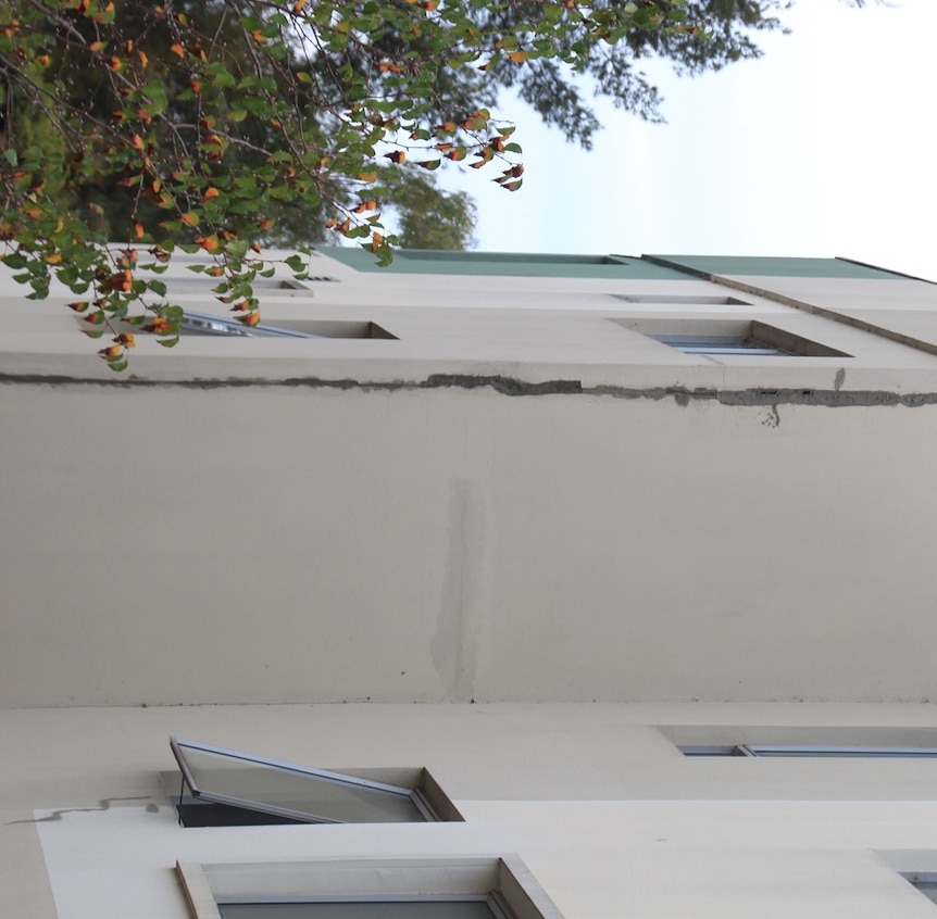 A long vertical crack running up the side of a multi-storey building.