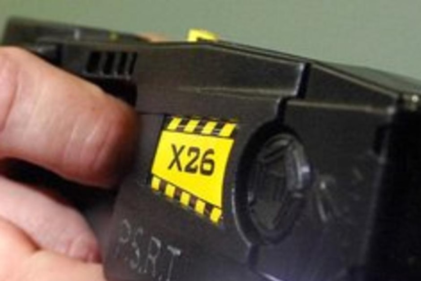 A man holds a taser gun