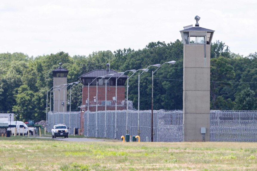 Office patrol the grounds of the federal prison in Terre Haute, Indiana, where Daniel Lewis Lee was executed.