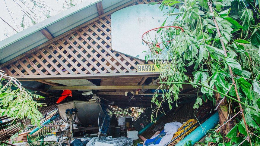 A shed collapses on a boat and household items