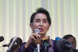 Aung San Suu Kyi addresses journalists during a press conference