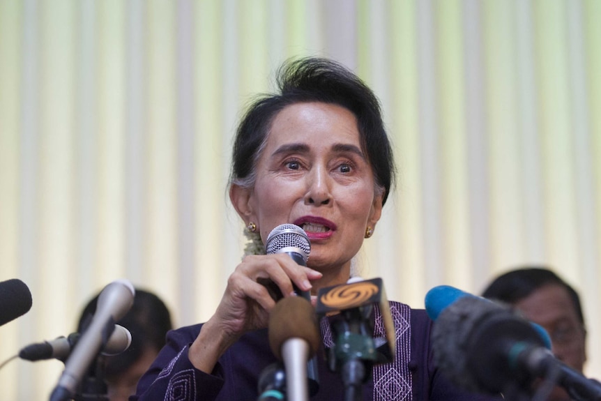 Aung San Suu Kyi addresses journalists during a press conference