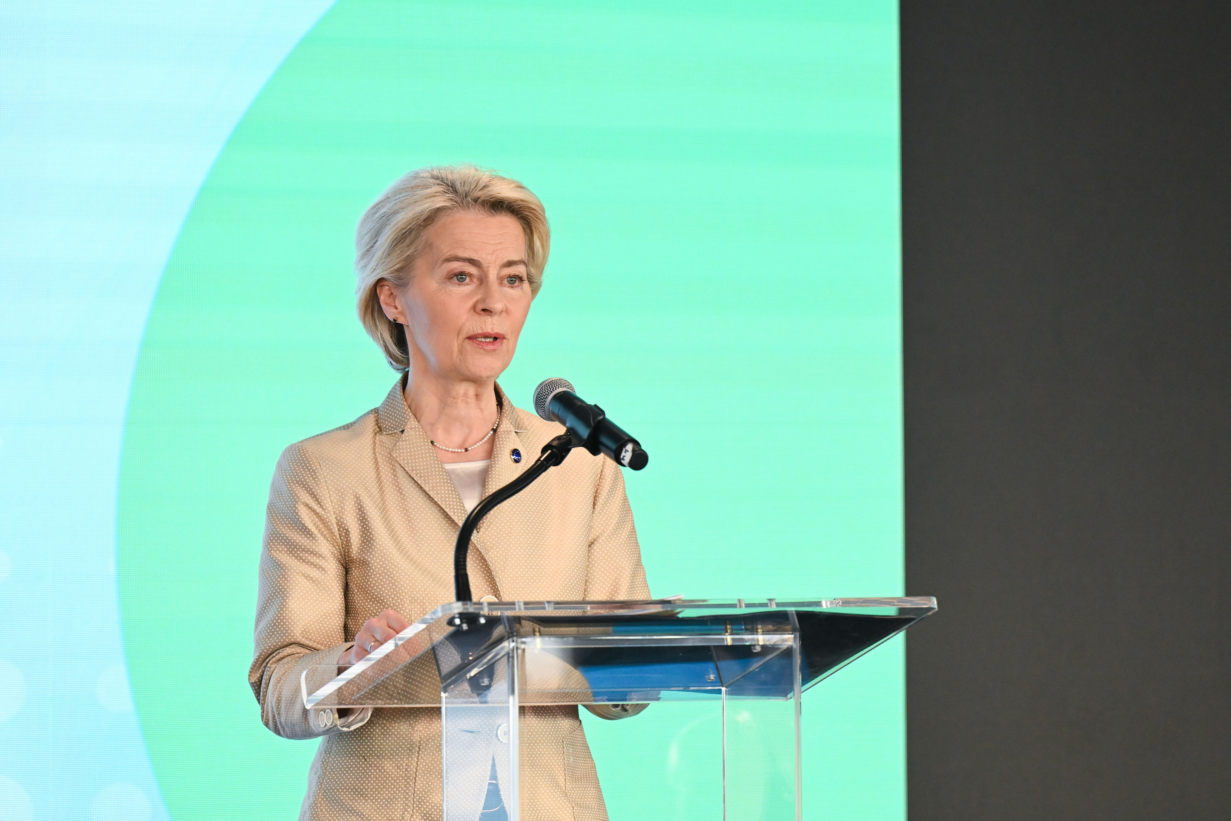 Ursula von der Leyen speaks at a microphone.
