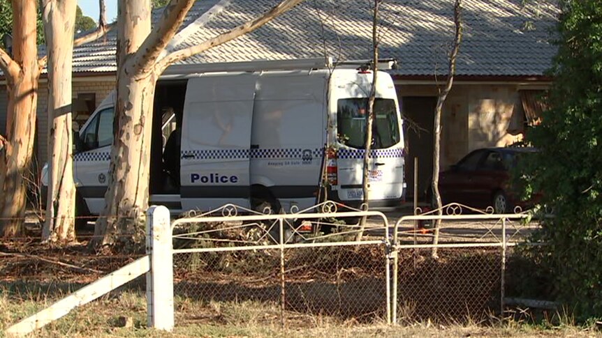A police van outside a home.