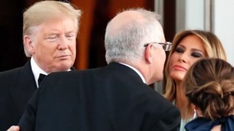 Scott Morrison kisses Melania Trump on the cheek.