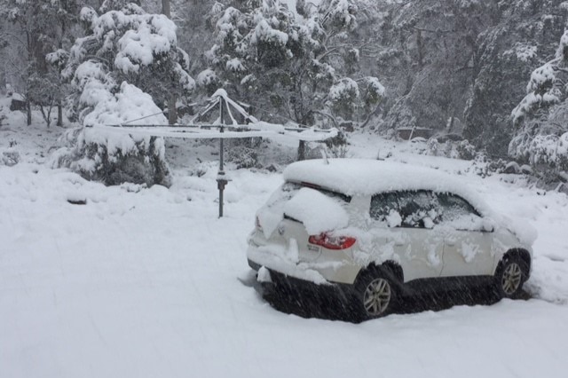 A car and clothesline covered in snow at Great Lake, Tasmania.