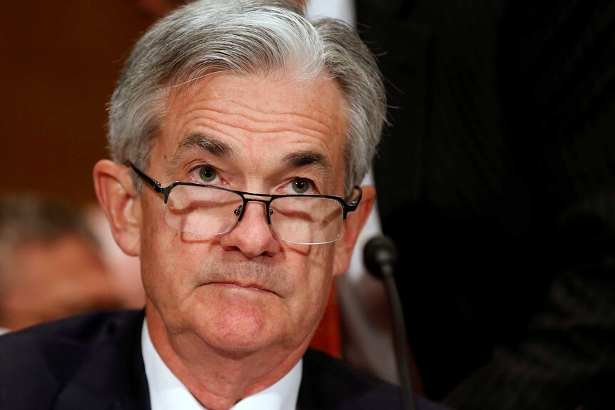 A tight head shot of Jerome Powell, he is wearing a blue tie.