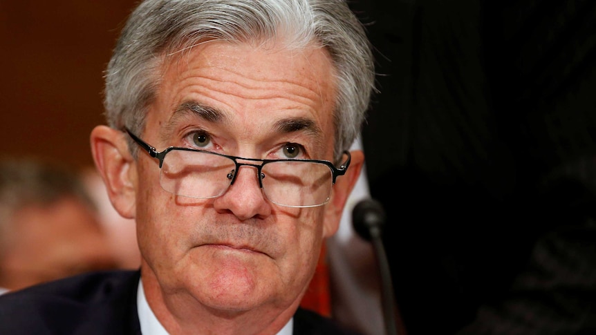 A tight head shot of Jerome Powell, he is wearing a blue tie.