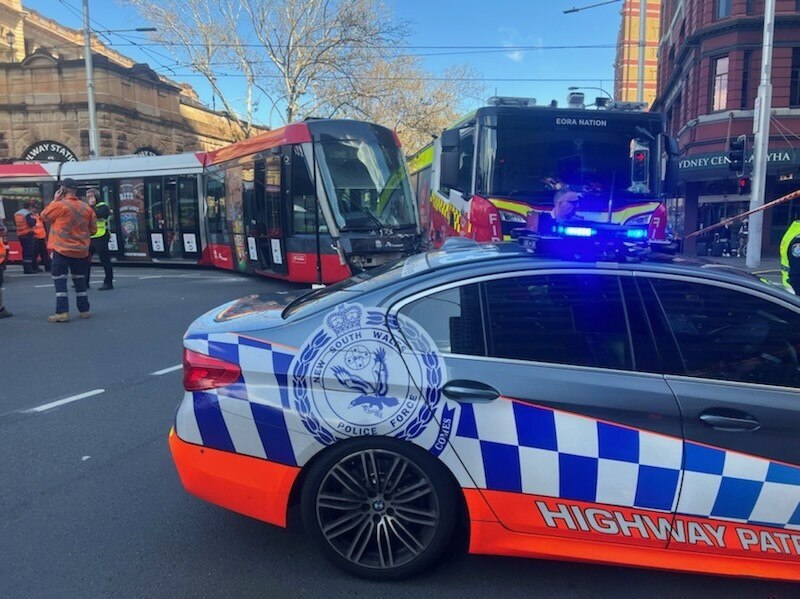 A police car next to a tram crashed into a fire truck
