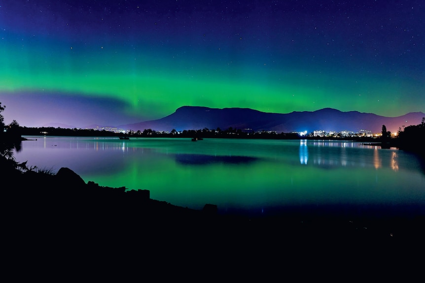 Green array of light over dark night sky of Hobart