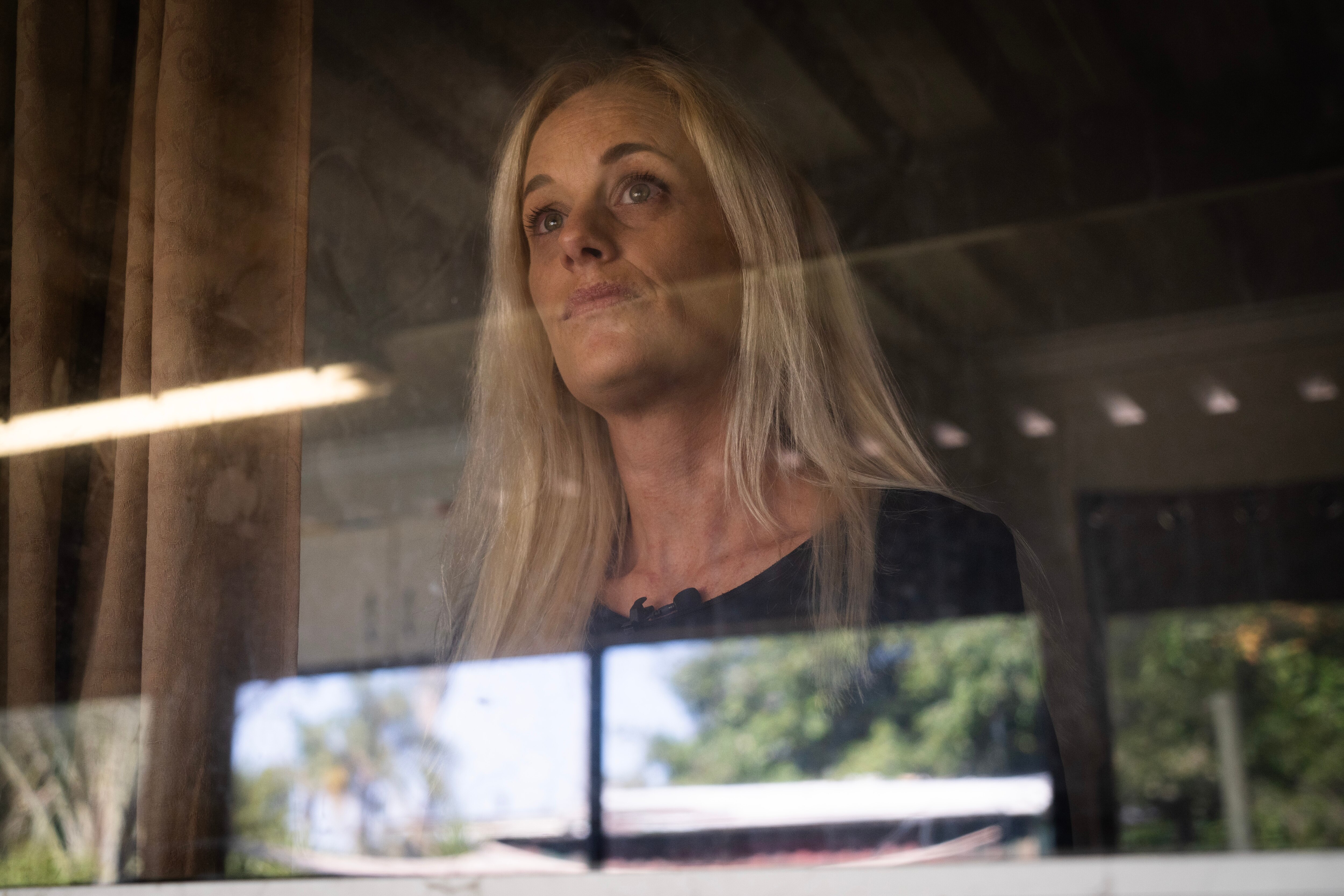 woman looking out window