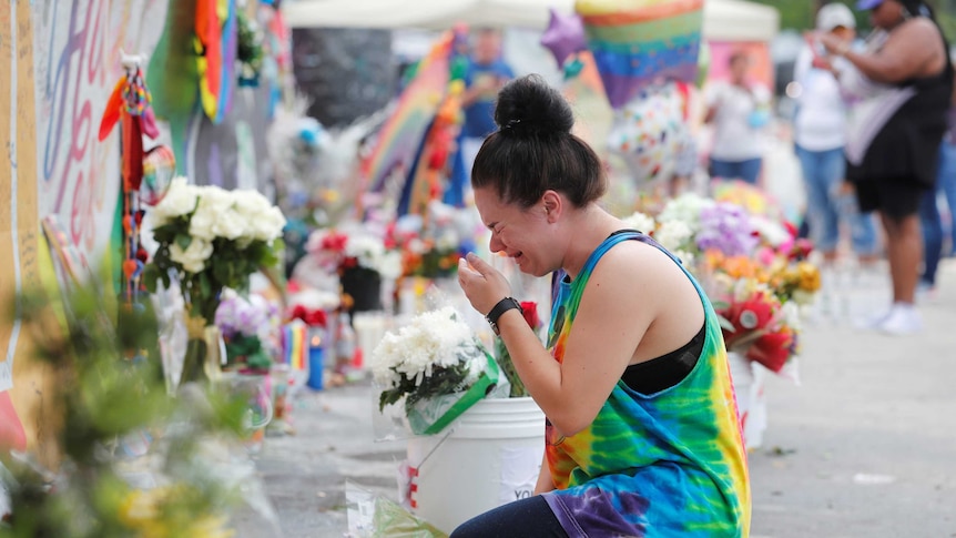 Chelsea Nylen reacts while visiting the memorial outside the Pulse Nightclub