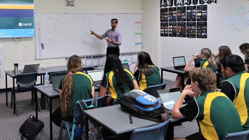 Teacher stands at front of class at Emerald State High School.