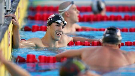 Michael Phelps smiles at US team-mate and bronze medal winner Ryan Lochte after 200m IM