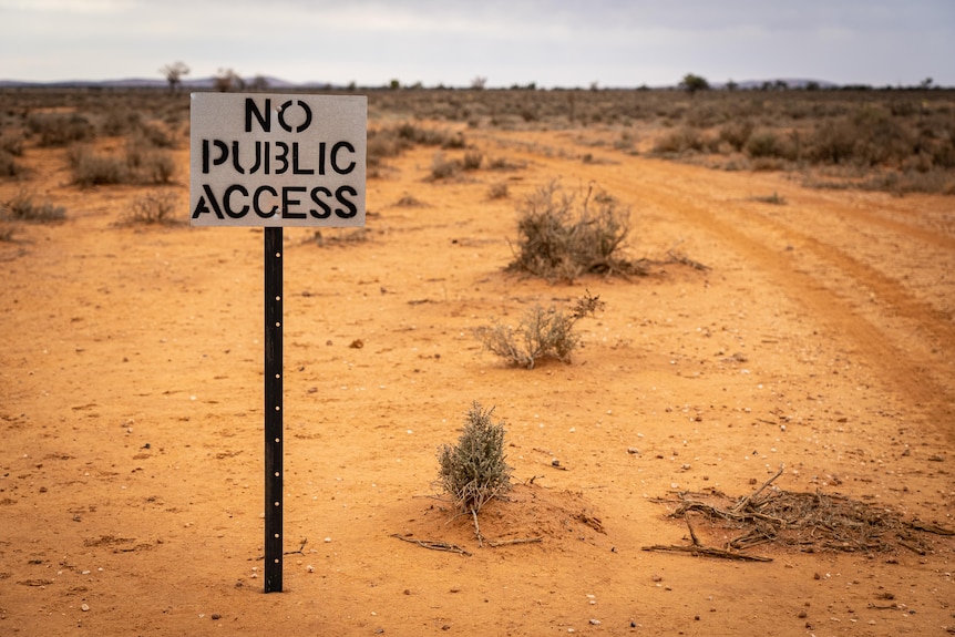 A sign reading 'No public access' stands in front of bushland