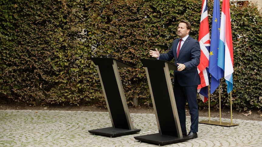 Xavier Bettel addresses a press conference beside an empty lectern, after Boris Johnson declines to participate.