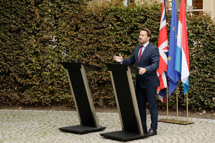 Xavier Bettel addresses a press conference beside an empty lectern, after Boris Johnson declines to participate.