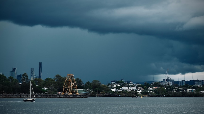Dark storm clouds over Brisbane river.