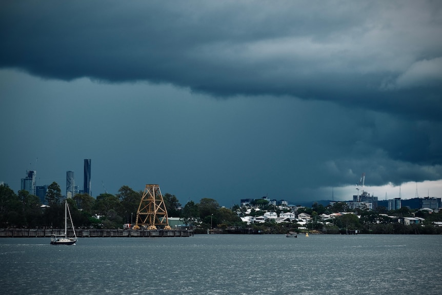 Dark storm clouds over Brisbane river.