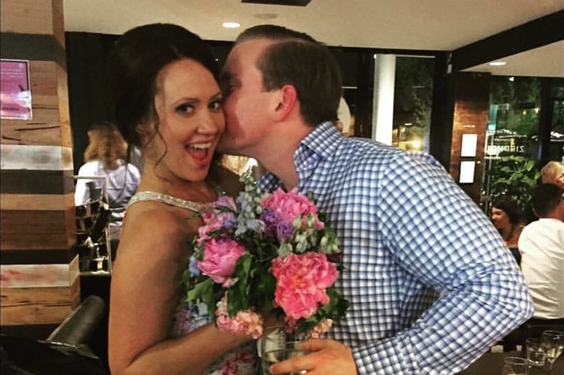 Melissa Laughlin with her partner, holding flowers