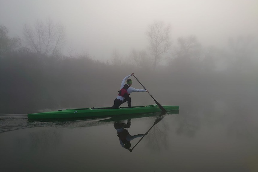 A boy on a canoe.