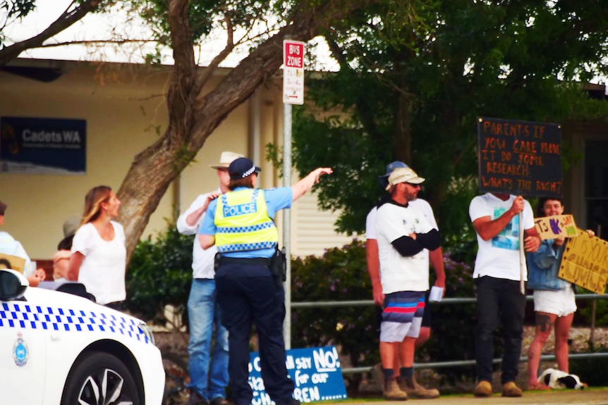 A police officer and a group of protesters