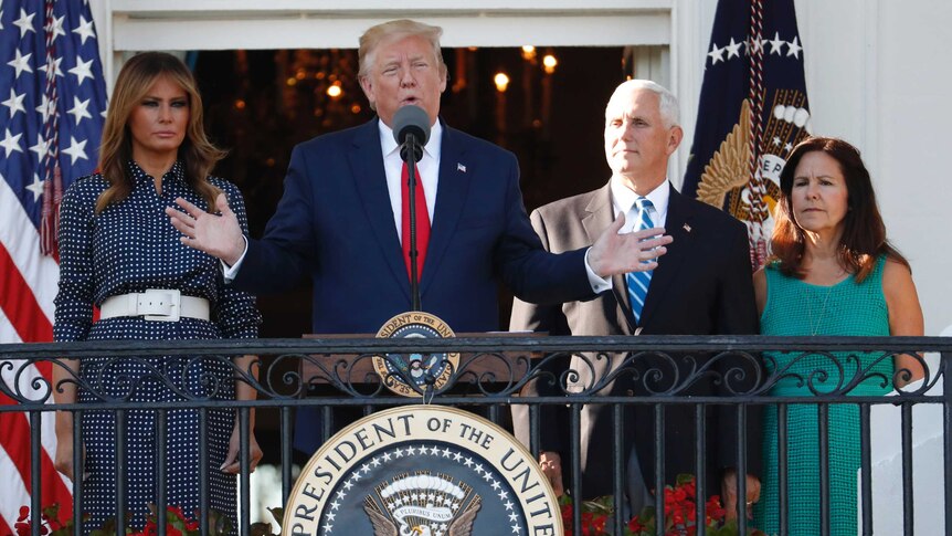 Donald Trump, Melania Trump, Mike Pence and Karen Pence stand on a balcony.