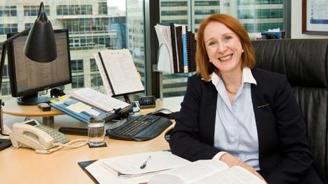 Rosalind Croucher sits at her desk.