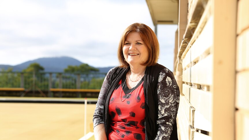 Shelley Hancock sits on a bench at the Bomaderry Bowling Club.