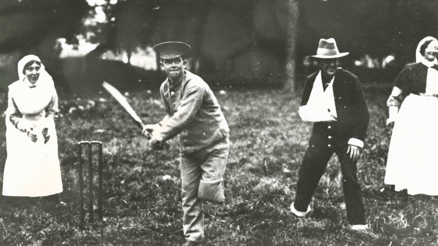 A soldier with only one leg plays a game of recreational cricket with nurses