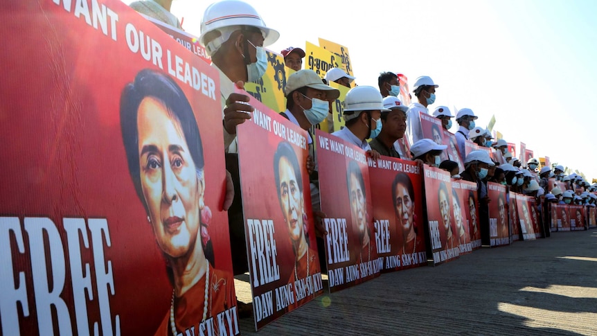 Demonstrators hold placards with the image of Aung San Suu Kyi during a protest against the military coup, in Naypyitaw, Myanmar