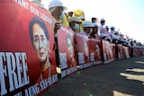 Demonstrators hold placards with the image of Aung San Suu Kyi during a protest against the military coup, in Naypyitaw, Myanmar