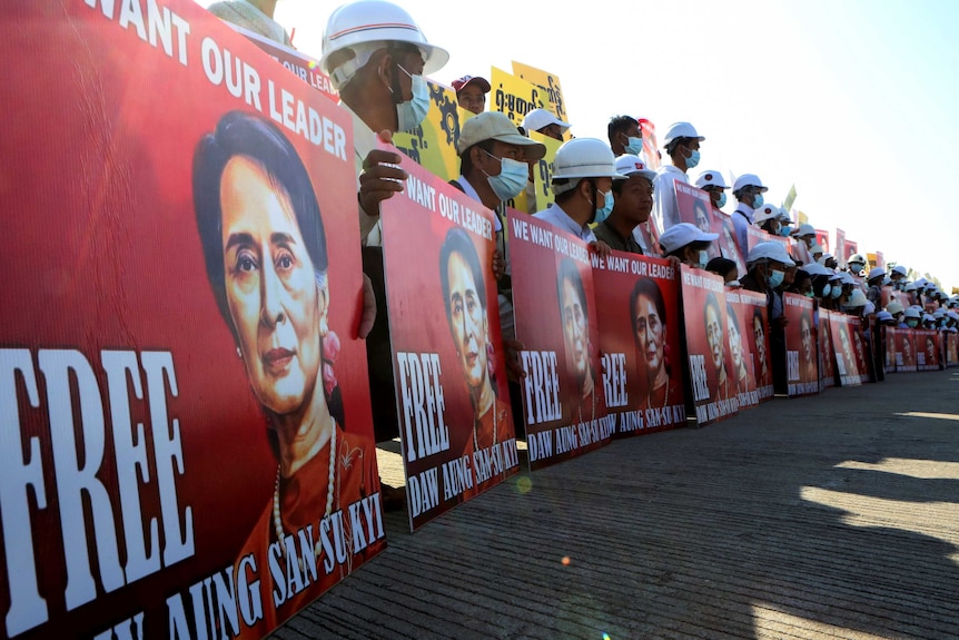 Demonstrators hold placards with the image of Aung San Suu Kyi during a protest against the military coup, in Naypyitaw, Myanmar