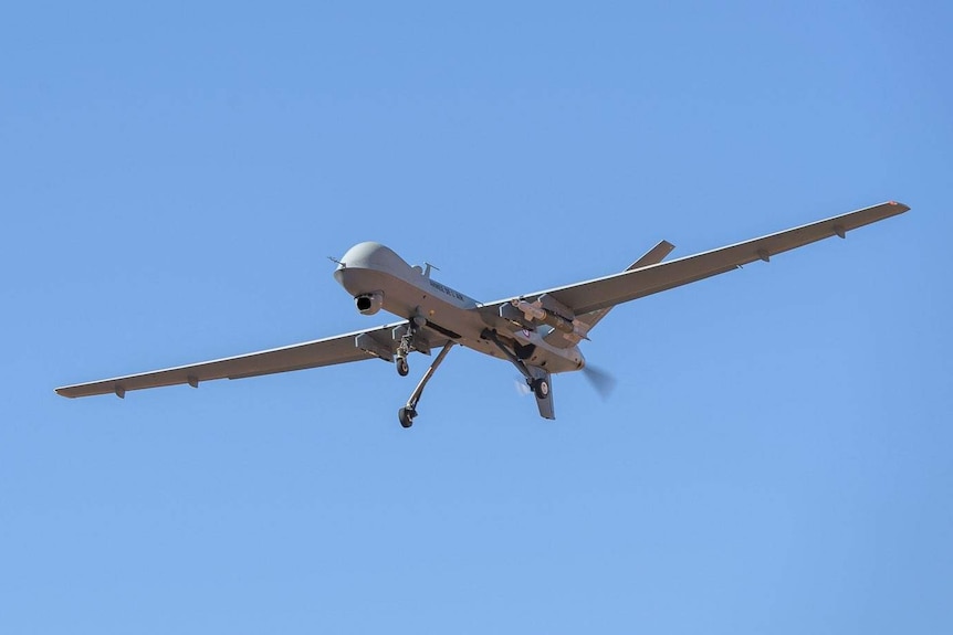 A grey military drone in the shape of an aeroplane.